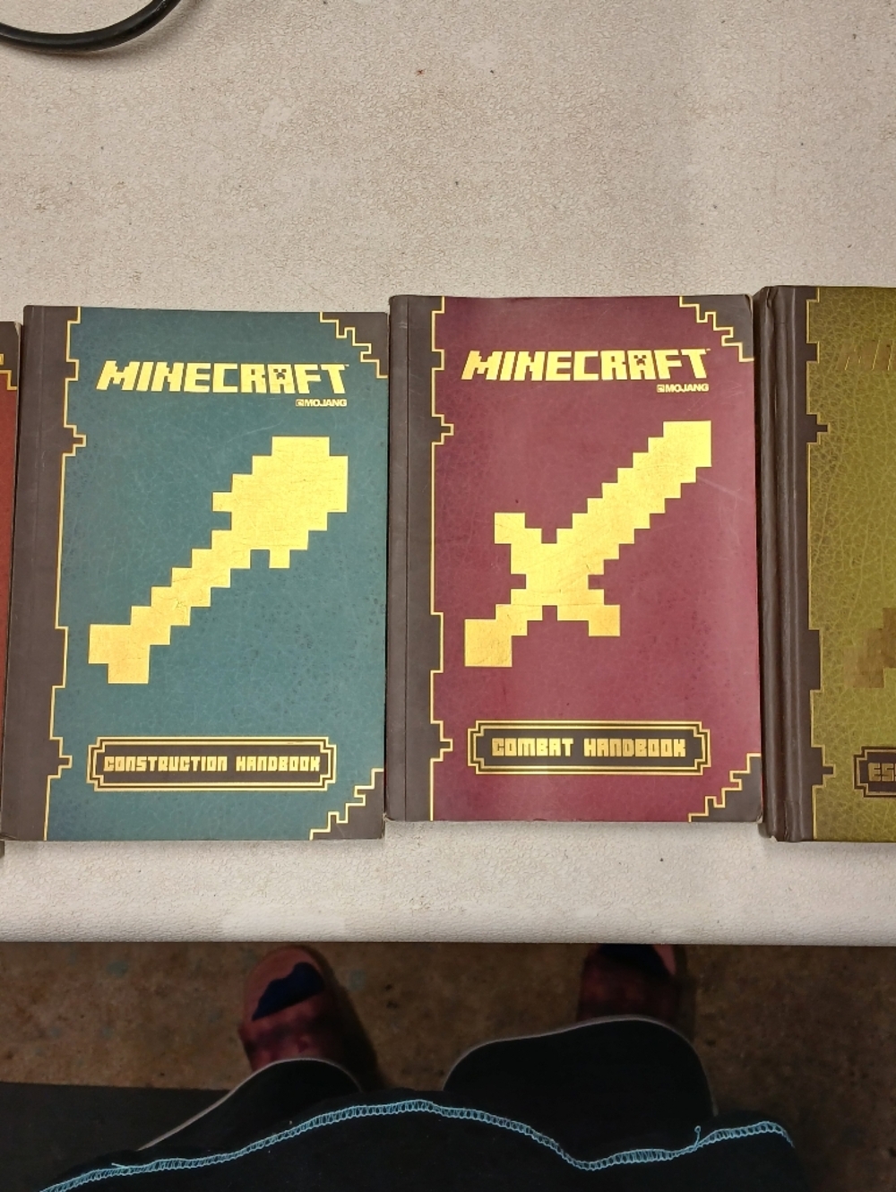 Scholastic Minecraft Hardcover Handbooks in Teal, Red, and Olive